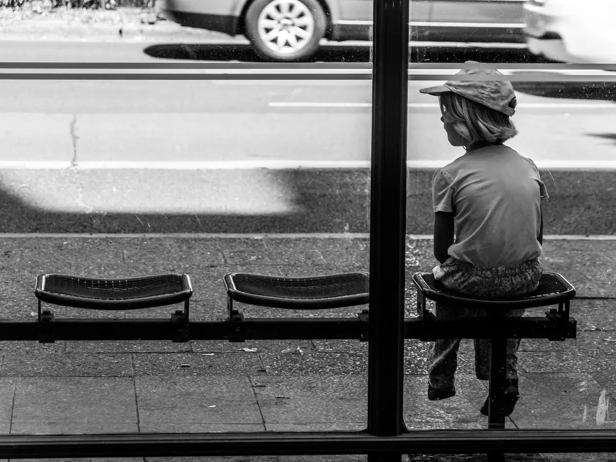 Child at a bus stop