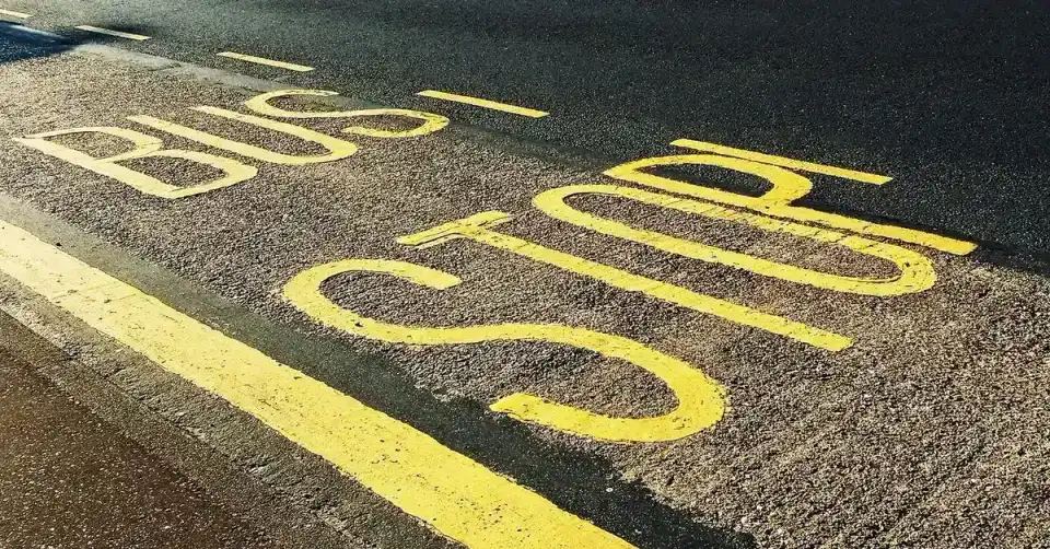 Bus stop sign by the road
