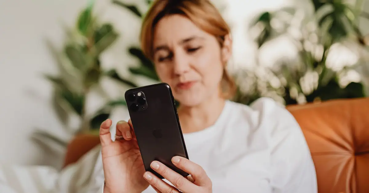 Parent reading a message on her phone