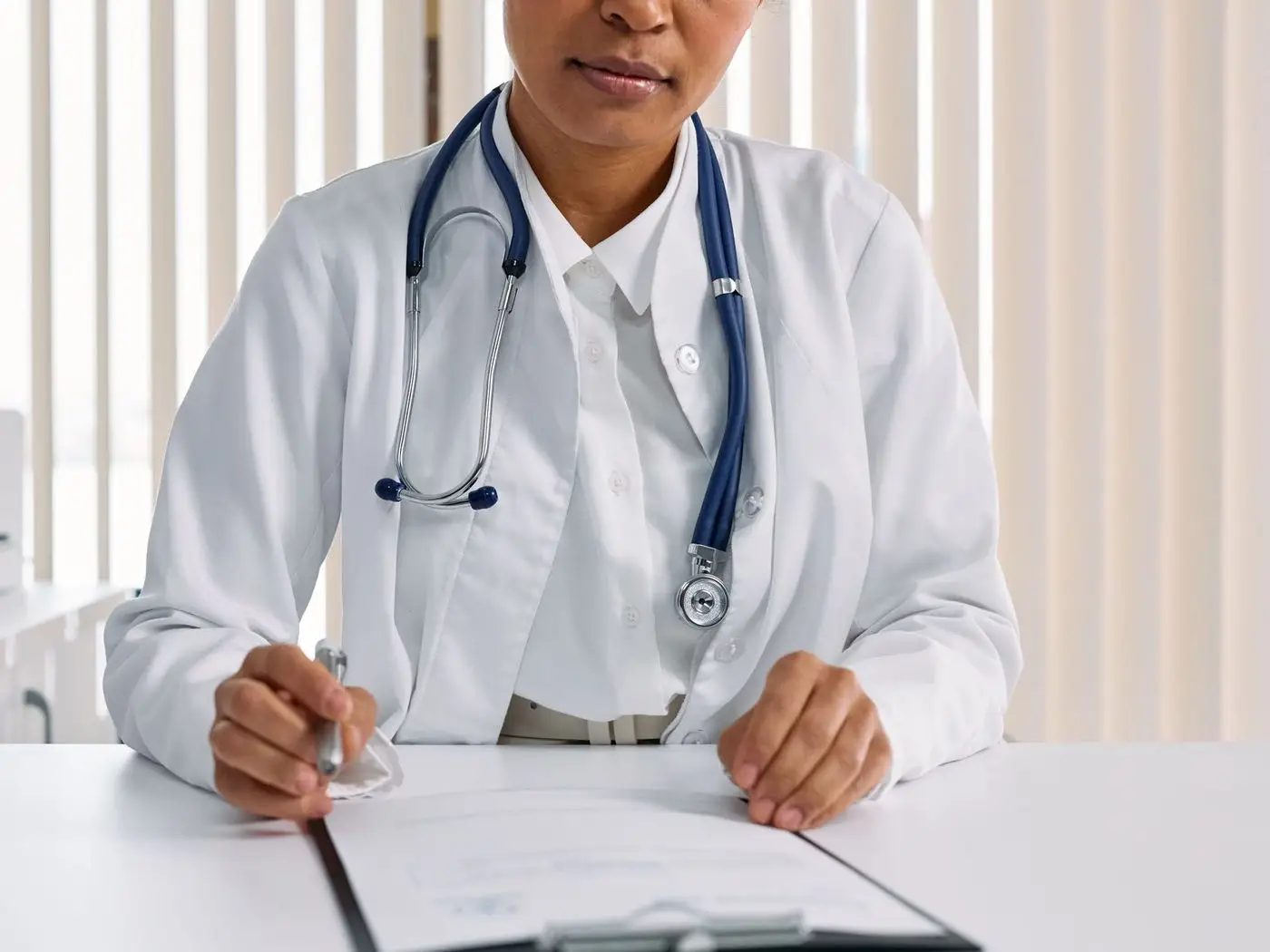 Clinic reception with a tablet showing a doctor profile and appointment timings page